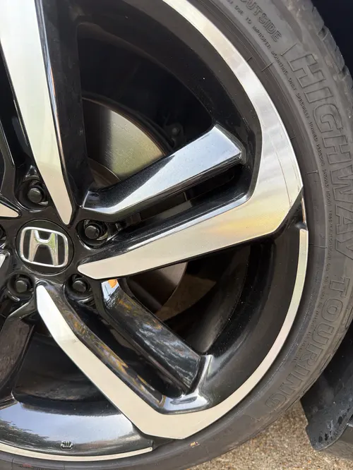 Close-up of a clean two-tone Honda alloy wheel and tire